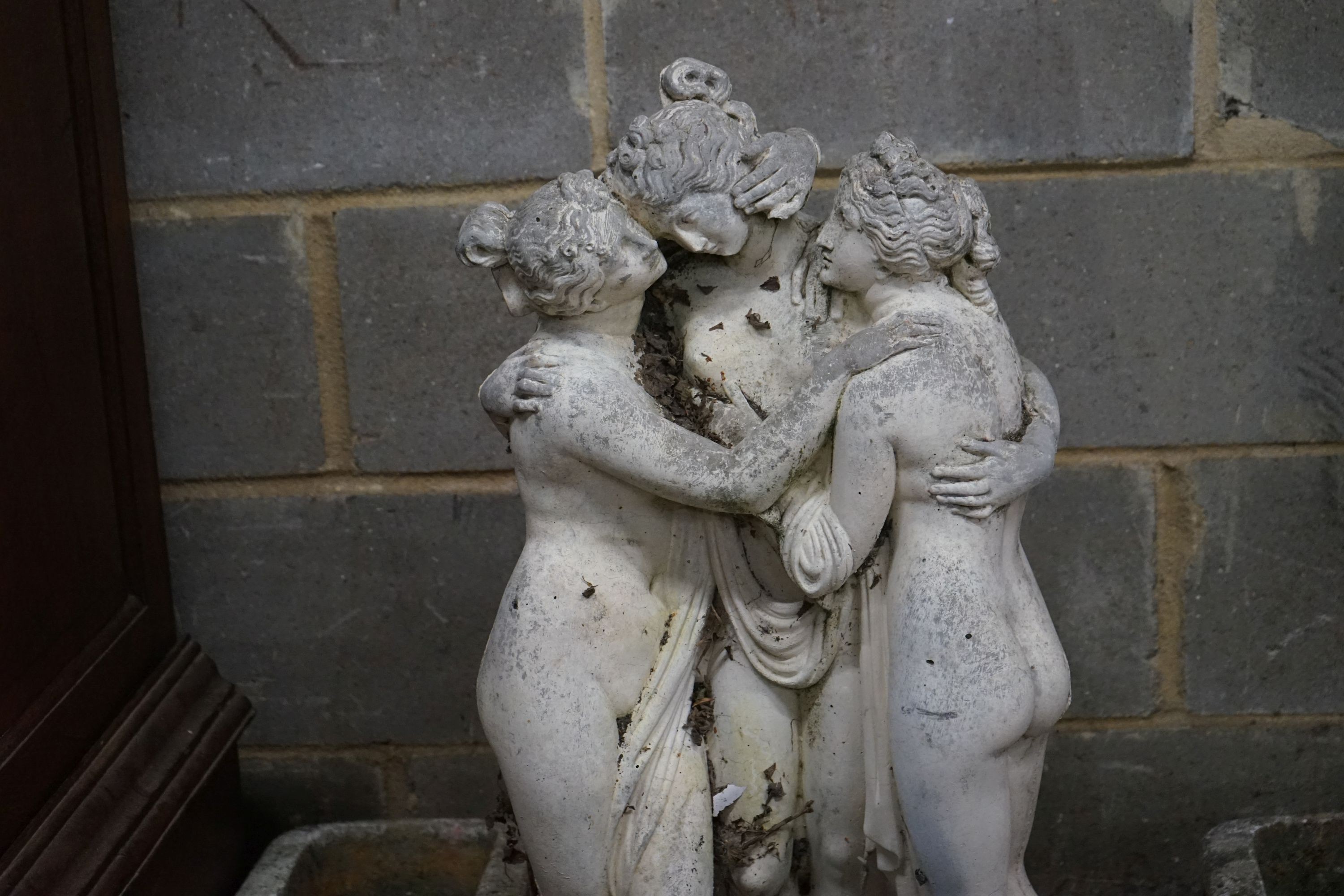 A reconstituted stone garden ornament, the Three Graces, height 84cm together with three planters